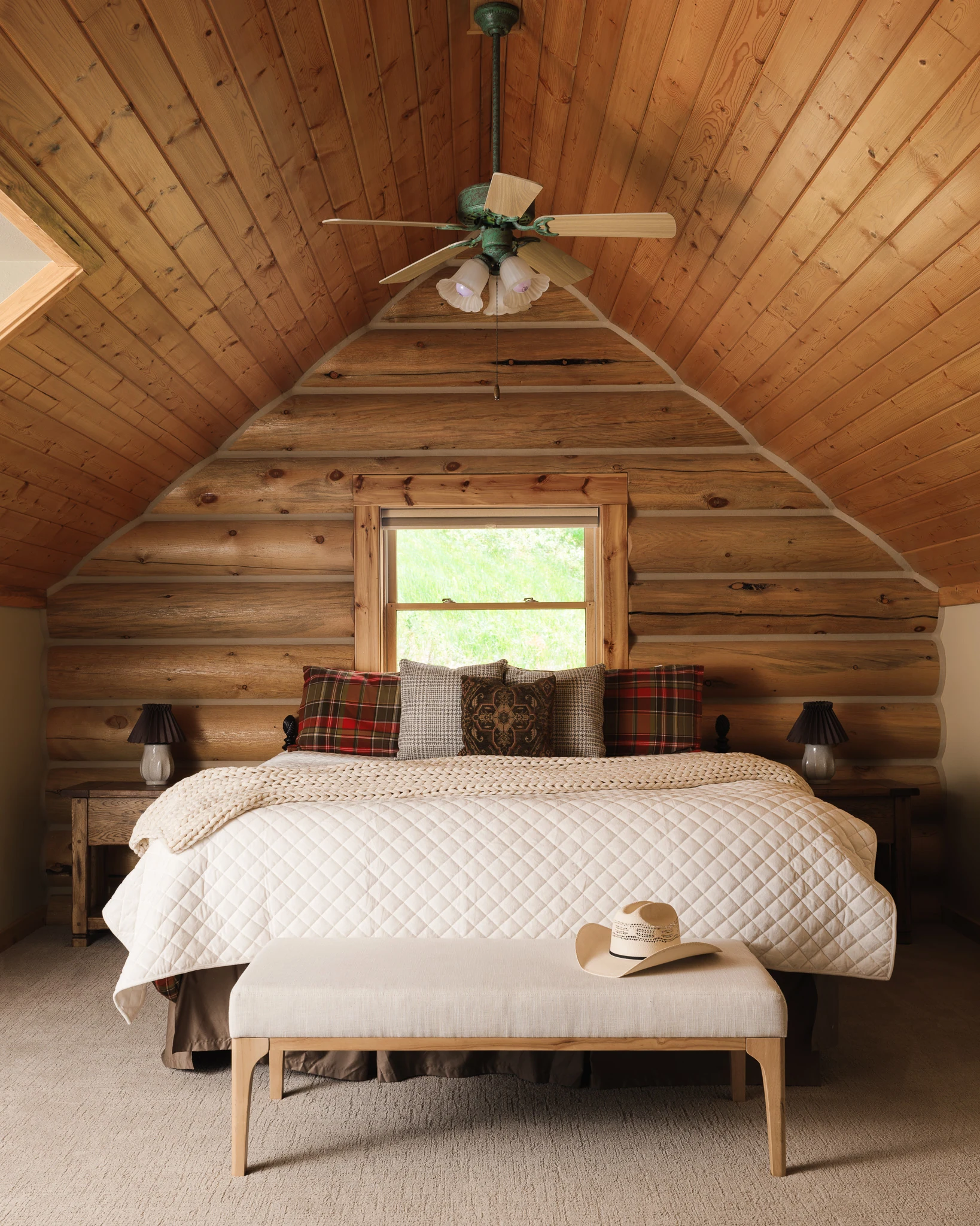 Attic bedroom with a ceiling fan and plaid throw pillows — interior design photography Livingston Montana, Bear Canyon Ranch